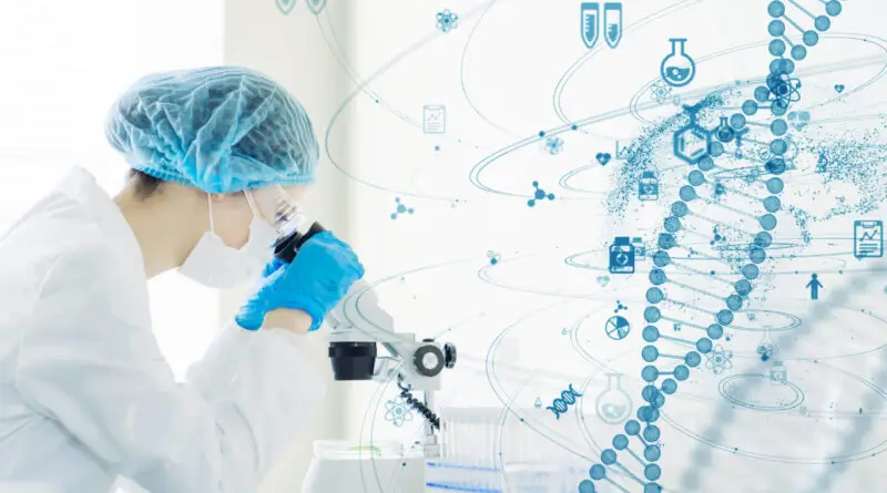 A researcher looking at her microscope analyzing DNA strands.