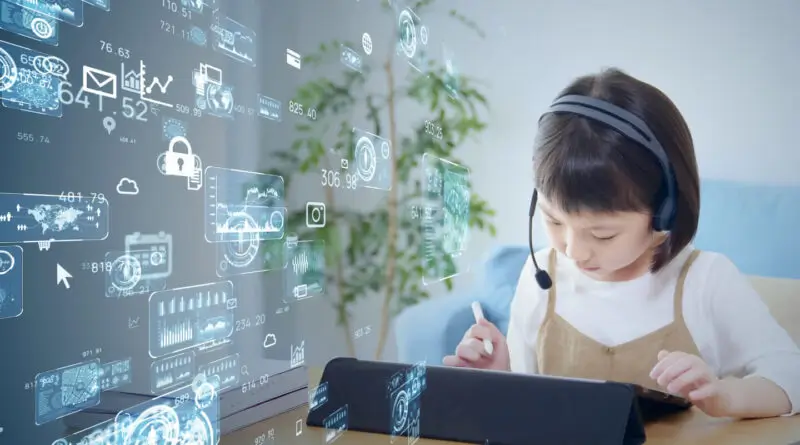 young girl sitting in front of a computer