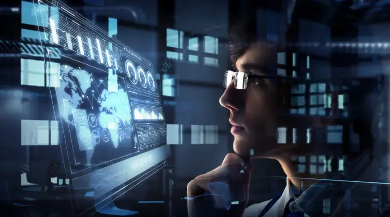 man viewing computer screens